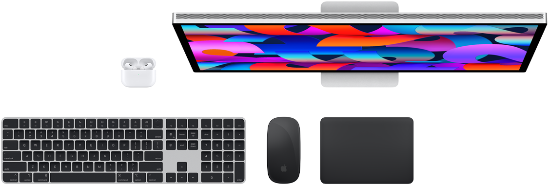 Vista de cima dos acessórios Mac: Studio Display, AirPods, Magic Keyboard, Magic Mouse e Magic Trackpad